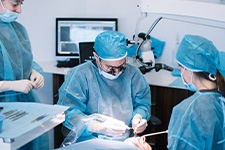 an oral surgeon performing dental implant placement