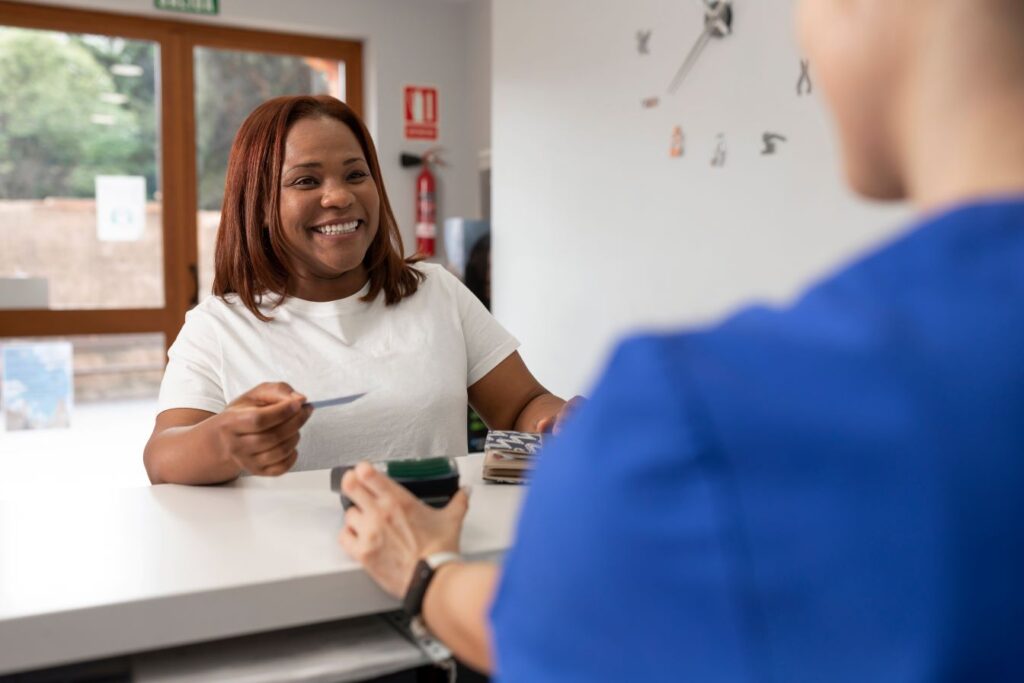 A woman paying for her dental appointment